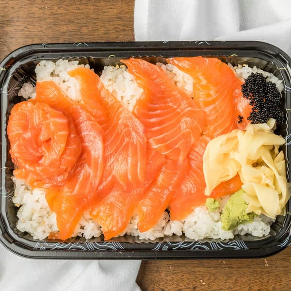 Kei Sushi Restaurant's salmon sashimi over rice, with black caviar, pickled ginger, and wasabi.